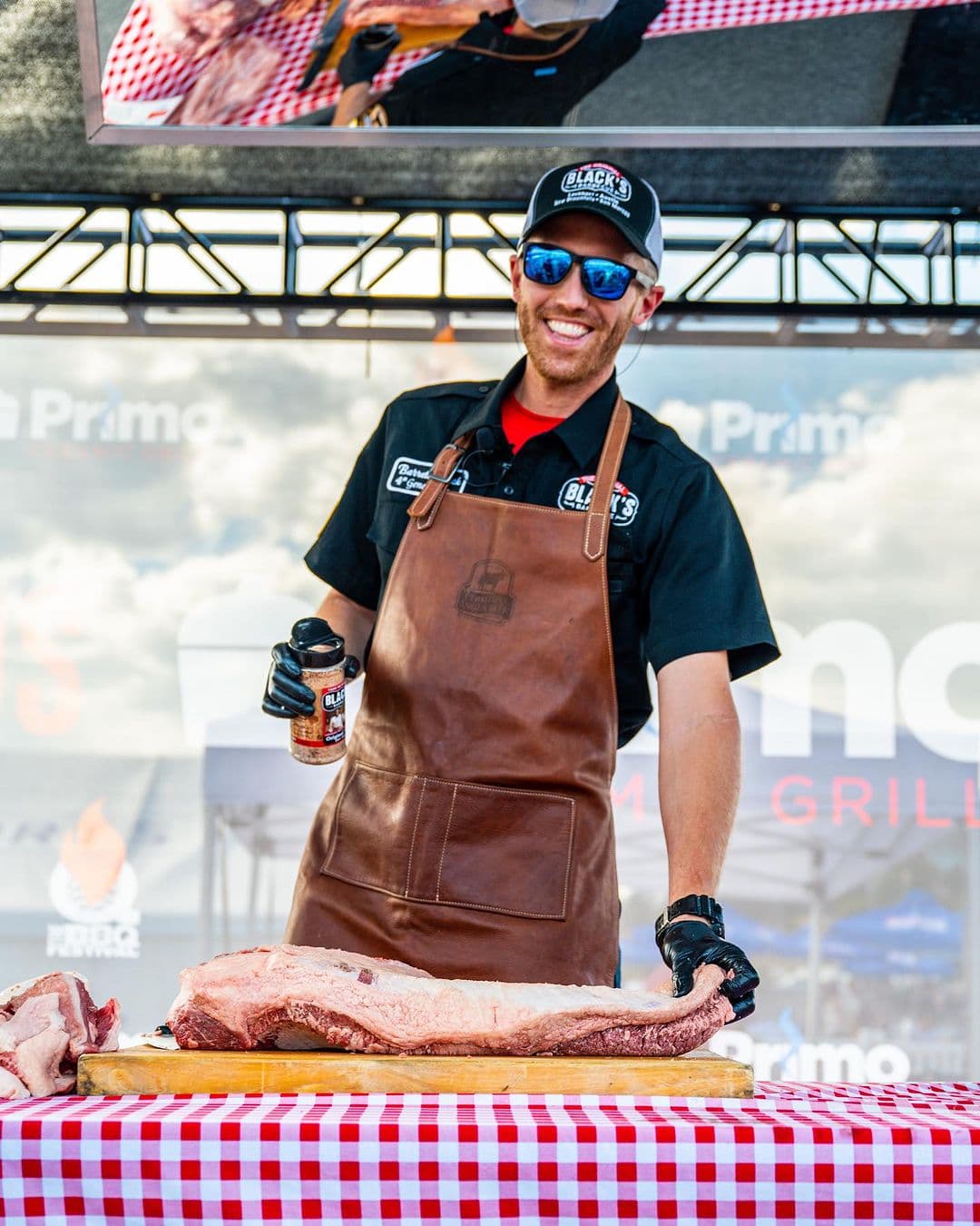 man seasoning meat at table